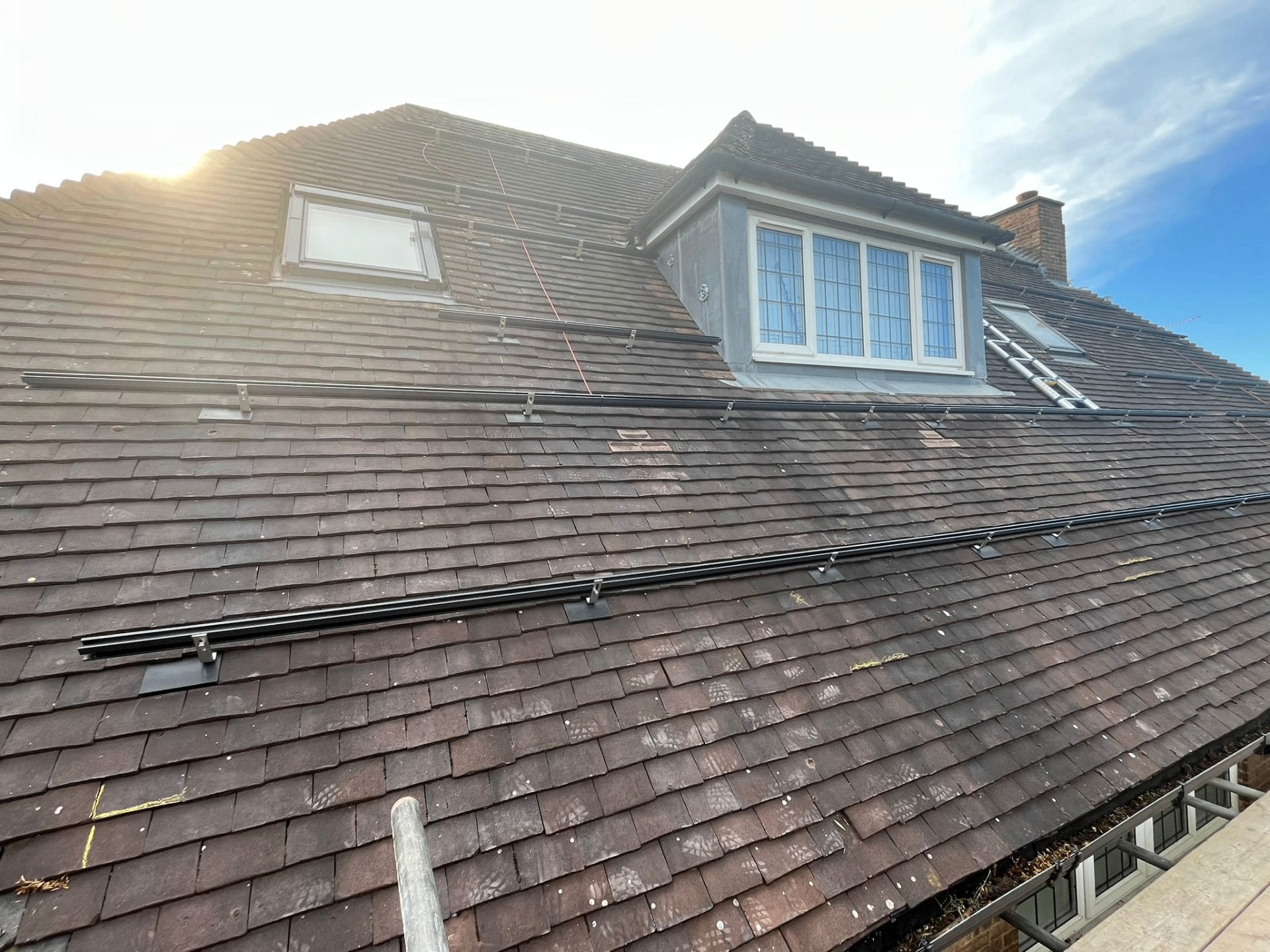 Before: solar panel mounting rails fitted to a UK tile roof, ready for panels — early stage of a Makse Electrical installation